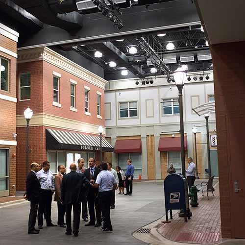 Inside the HEC immersive training street at College of DuPage — a full-scale indoor streetscape with brick storefronts, street lamps and a mailbox, where first responders run scenario exercises